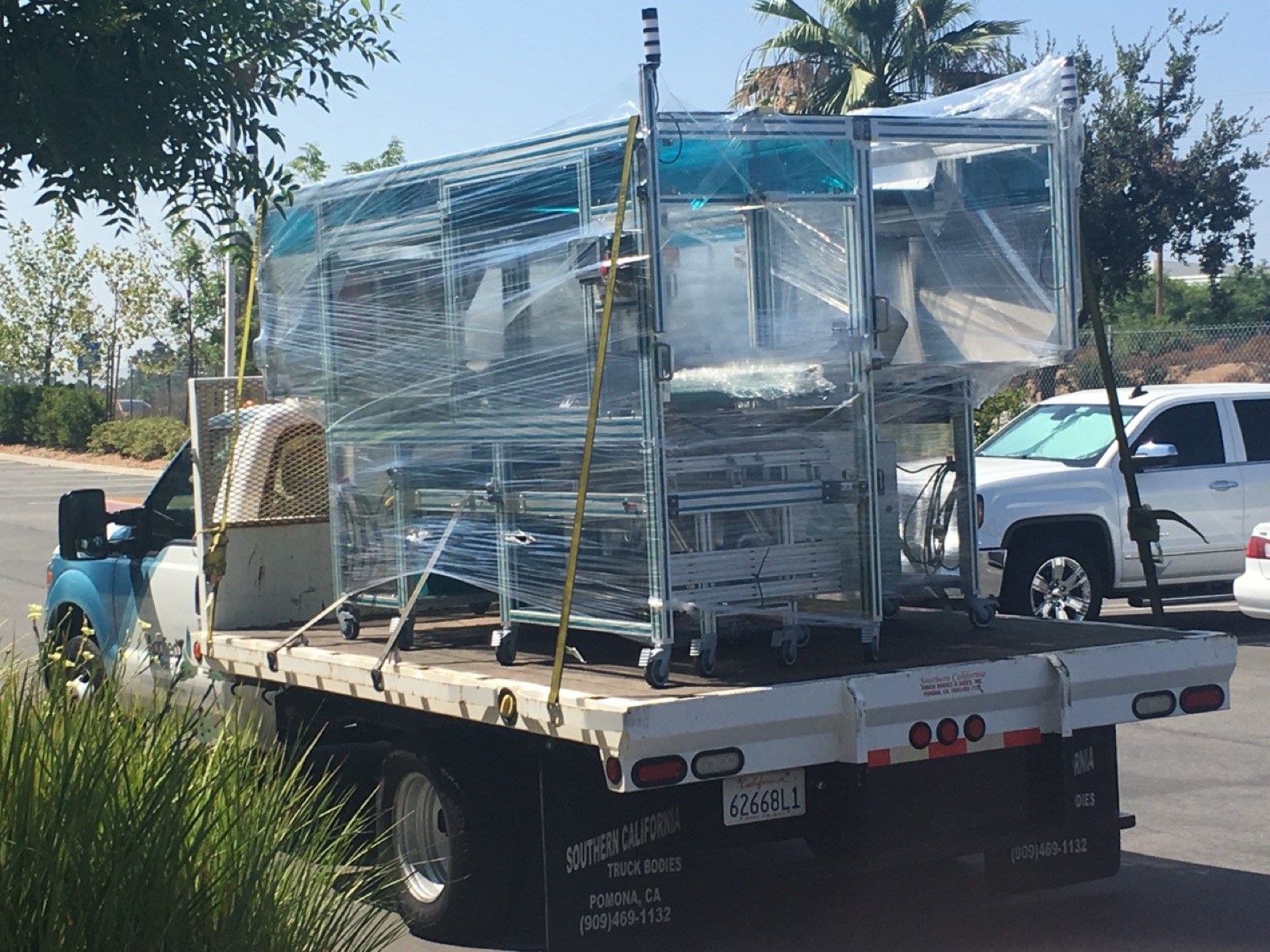 Manufacturing automation equipment wrapped on a flatbed truck.